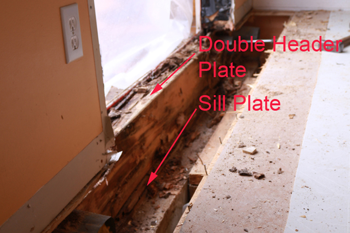 Damaged header and sil plates exposed